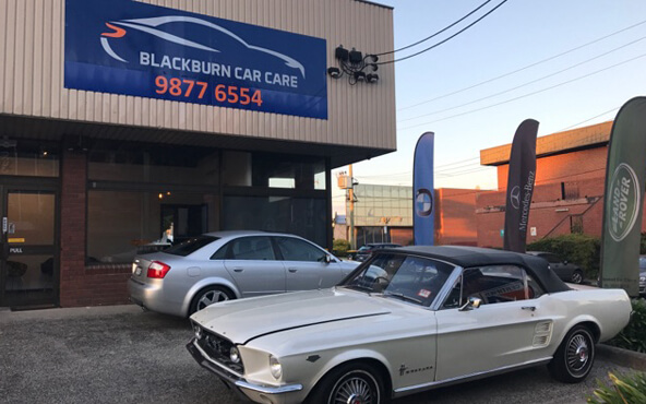 Two prestige cars parked outside Blackburn Car Care service workshop